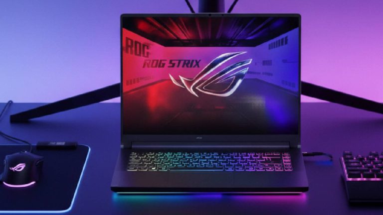 Asus ROG Strix G16 laptop on a gaming desk next to an RGB mouse and keyboard.